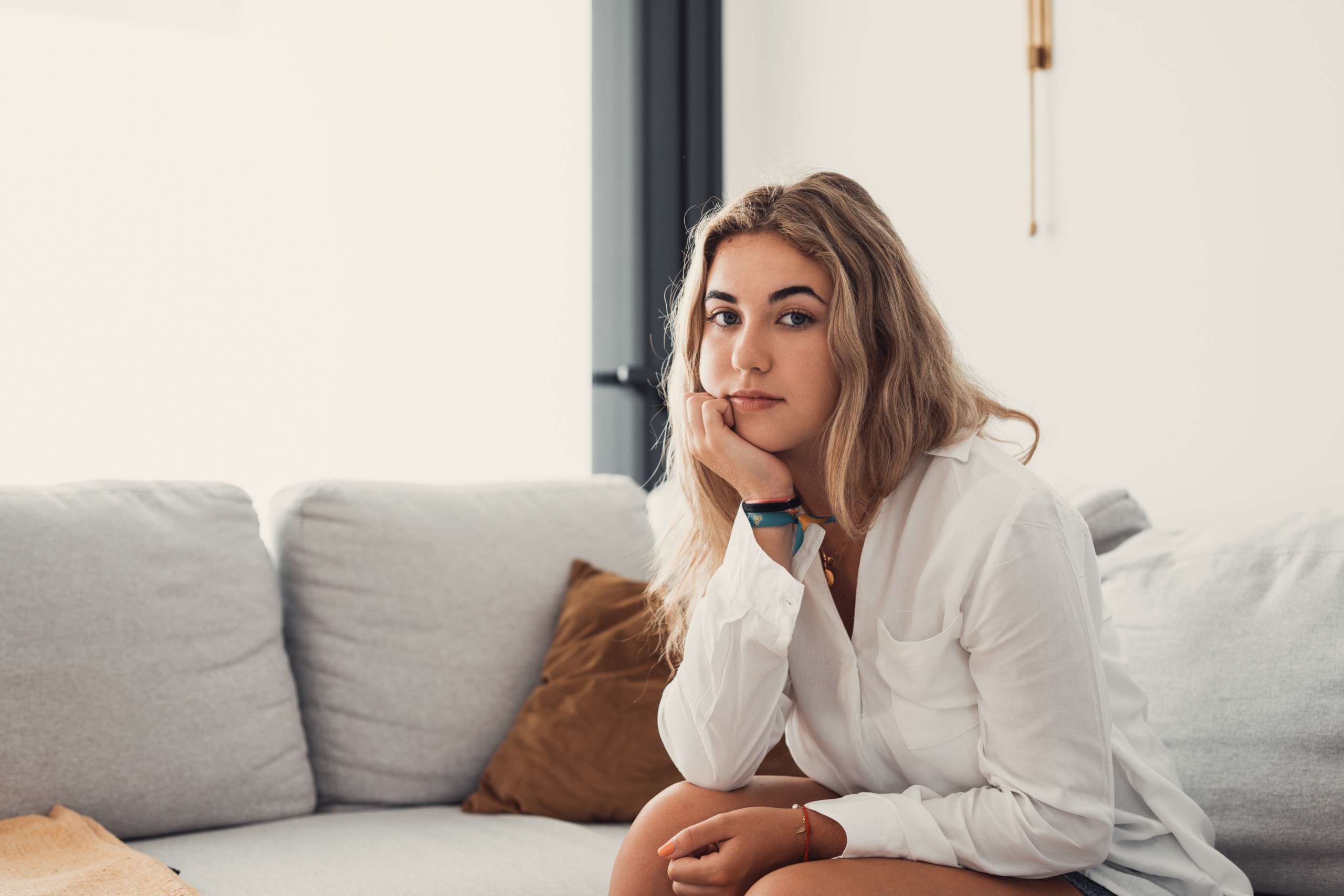 young woman sitting on couch